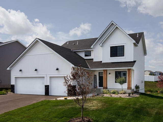 modern farmhouse featuring a garage and a front lawn