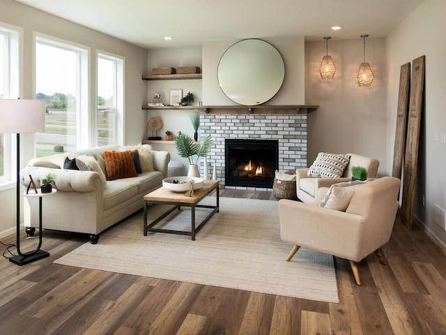 living room with a fireplace and dark hardwood / wood-style flooring