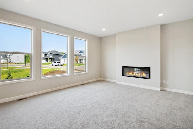 unfurnished living room with light colored carpet