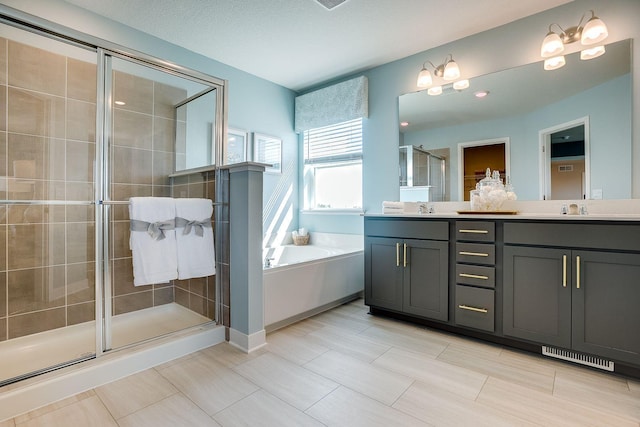 bathroom featuring a textured ceiling, vanity, and shower with separate bathtub