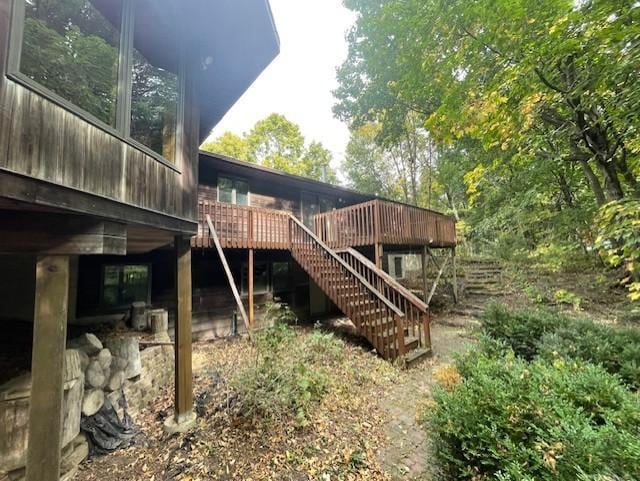 rear view of house featuring a wooden deck