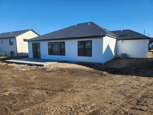 rear view of property featuring central air condition unit and a patio