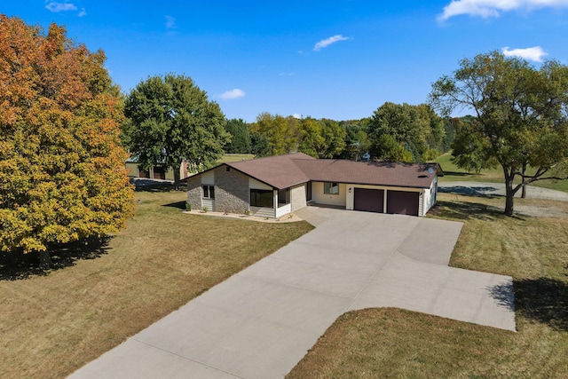 single story home featuring a garage and a front lawn