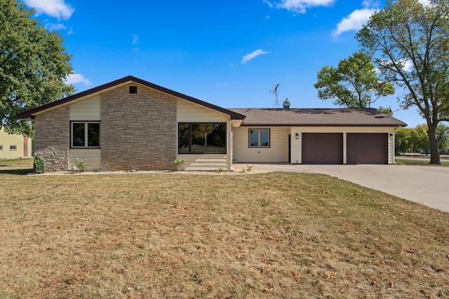 ranch-style house featuring a front yard and a garage