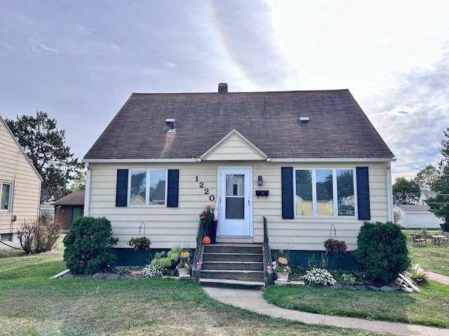 bungalow-style home with a front lawn