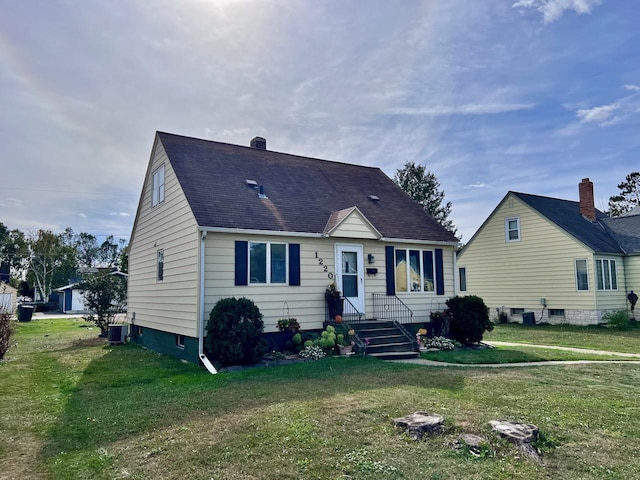 view of front of home featuring central AC and a front lawn