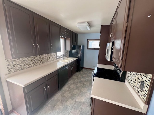 kitchen featuring sink, black appliances, dark brown cabinetry, and backsplash