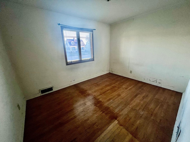 spare room with dark hardwood / wood-style flooring