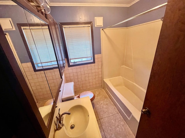 full bathroom with sink, toilet, tiled shower / bath, crown molding, and tile patterned flooring