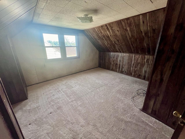 bonus room featuring lofted ceiling and light carpet