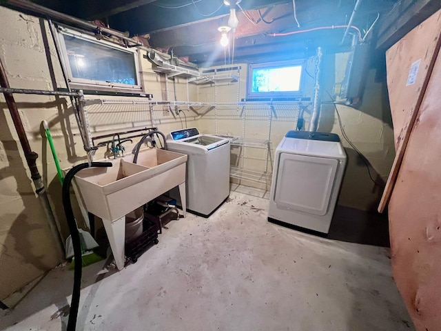 clothes washing area with washing machine and dryer