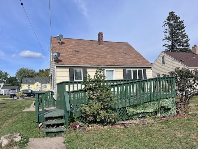 back of property with a yard and a deck