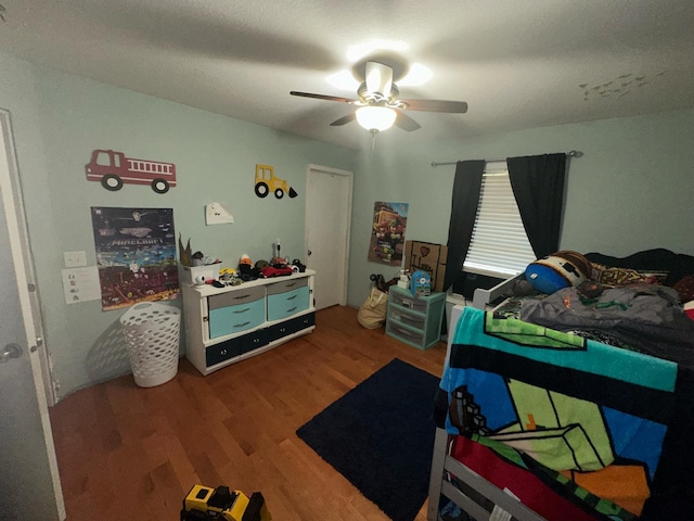 bedroom with wood-type flooring and ceiling fan