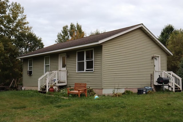 rear view of house featuring a yard