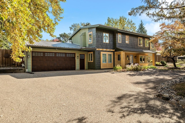 view of front facade with covered porch and a garage