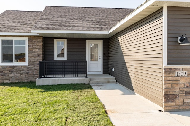 entrance to property featuring a yard