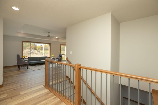 1309 18th St NE, Austin, MN 55912 - hallway featuring wood finished floors, recessed lighting, an upstairs landing, and a tray ceiling