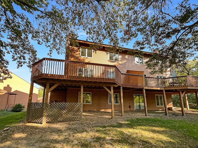 back of house featuring a yard and a deck