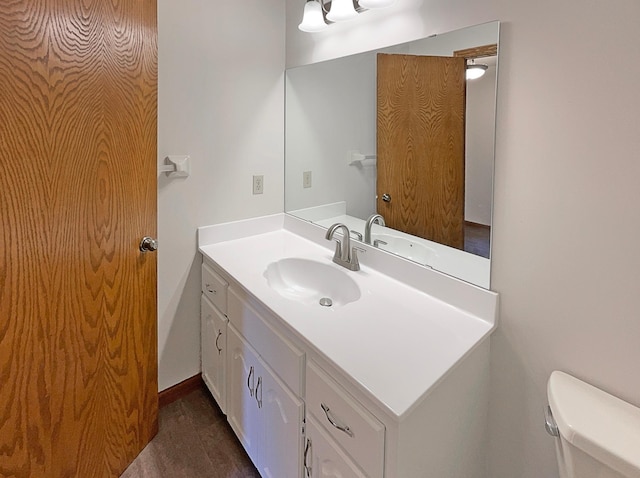 bathroom with toilet and vanity