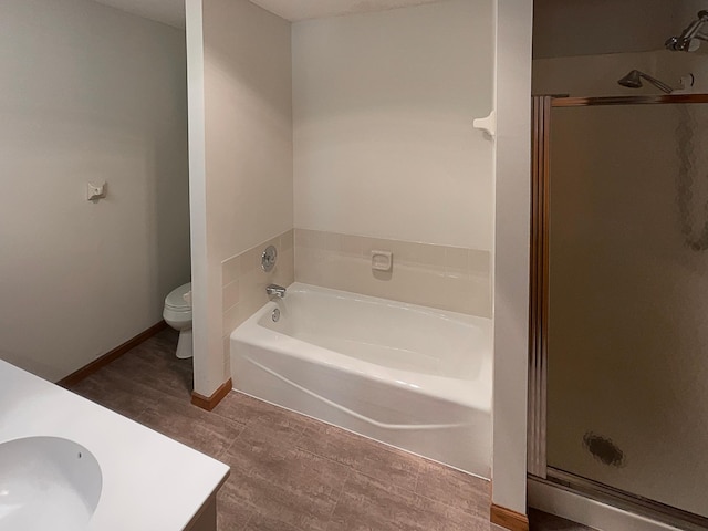 full bathroom featuring separate shower and tub, hardwood / wood-style flooring, vanity, and toilet