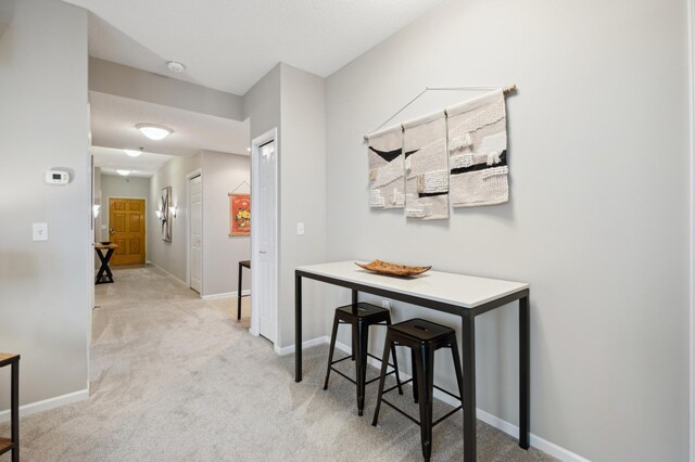 corridor with light colored carpet