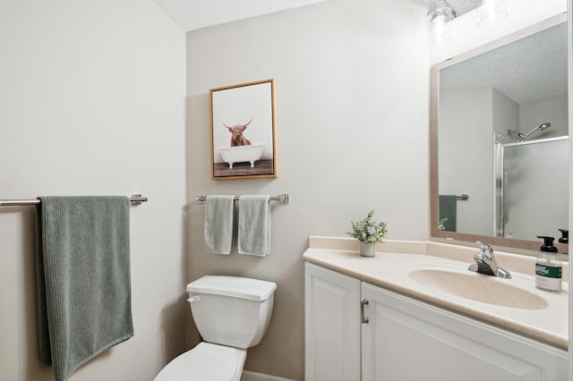 bathroom featuring toilet, a textured ceiling, walk in shower, and vanity