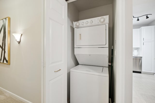 washroom featuring stacked washer and dryer