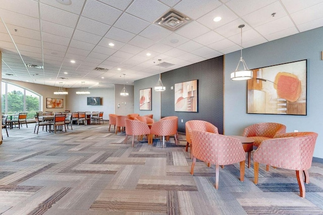 dining area featuring a drop ceiling