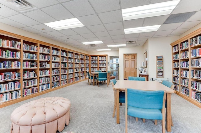 home office featuring a drop ceiling and light colored carpet