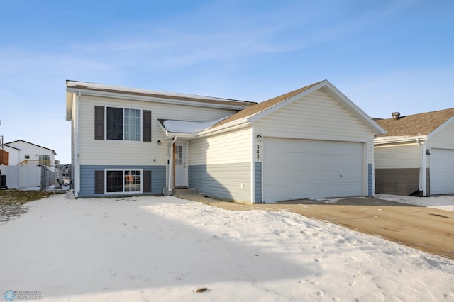 view of front facade featuring central AC unit and a garage