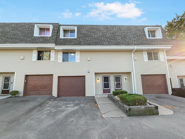 2360 Dorland Pl E, Maplewood, MN 55119 - townhome / multi-family property with an attached garage, driveway, mansard roof, and a shingled roof