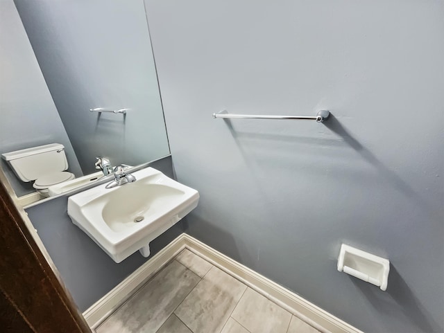 bathroom with sink, tile patterned flooring, and toilet