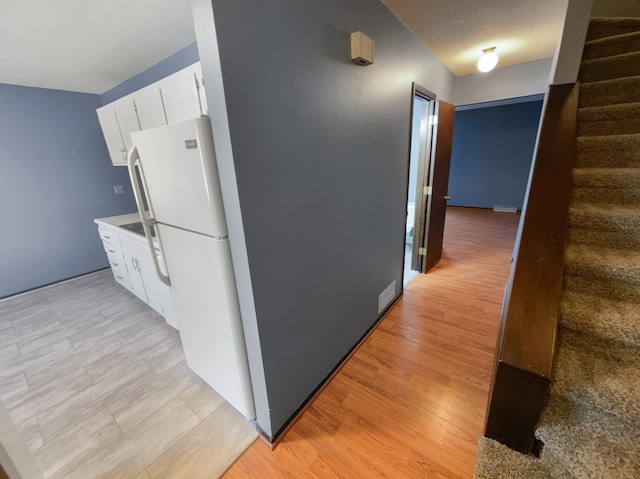 hall with light hardwood / wood-style flooring