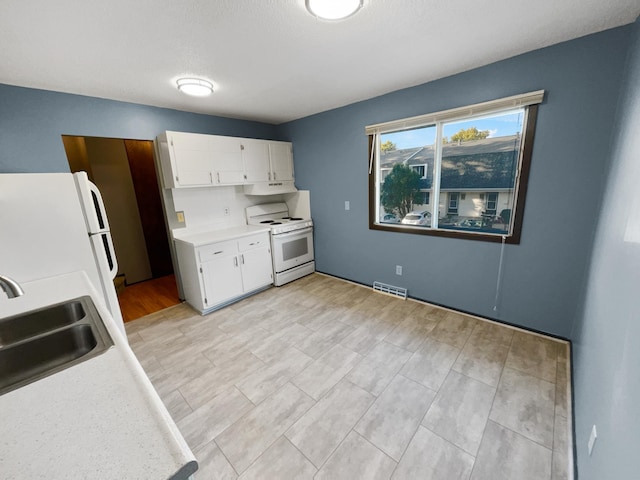 kitchen featuring white cabinets, light hardwood / wood-style flooring, sink, and white appliances