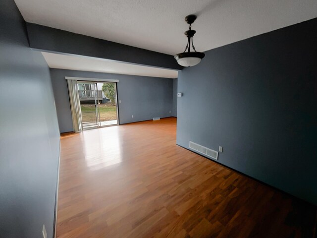 2360 Dorland Pl E, Maplewood, MN 55119 - unfurnished dining area with baseboards, wood finished floors, and visible vents