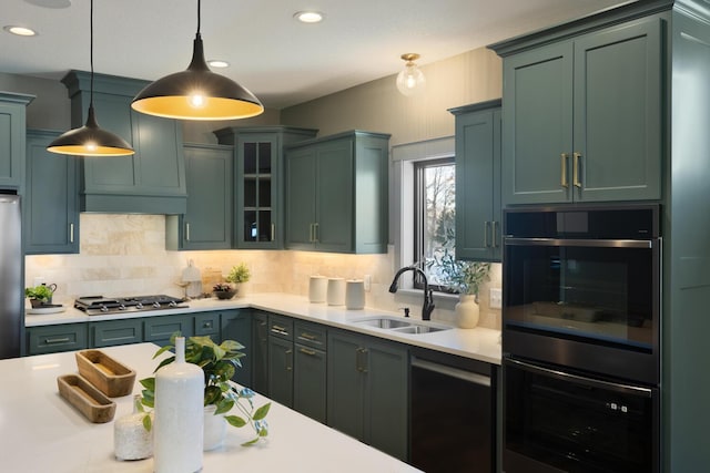 kitchen featuring pendant lighting, sink, backsplash, and appliances with stainless steel finishes