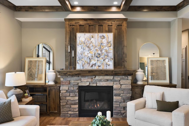 living room with beam ceiling, light wood-type flooring, and a fireplace