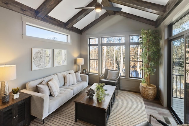 sunroom featuring lofted ceiling with beams and ceiling fan