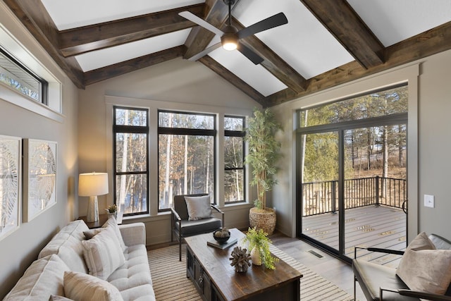 sunroom / solarium featuring ceiling fan and lofted ceiling with beams