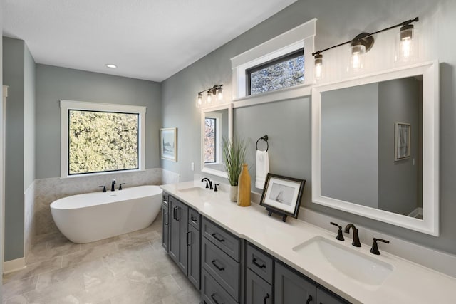 bathroom with vanity and a tub to relax in