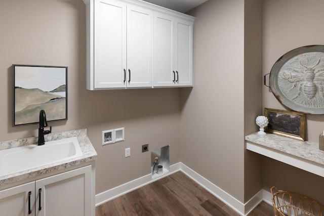 laundry area with dark wood-type flooring, sink, cabinets, hookup for a washing machine, and electric dryer hookup