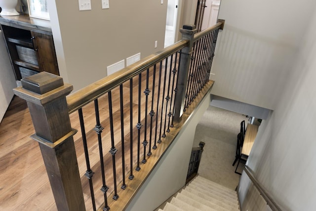 stairs featuring hardwood / wood-style floors