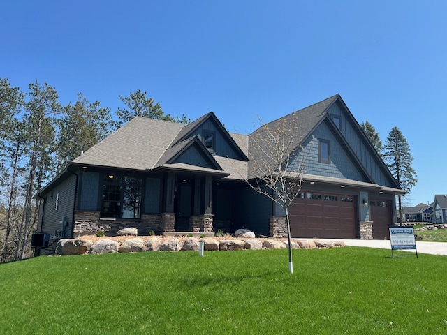 9998 211th Ct N, Forest Lake, MN 55025 - craftsman inspired home with stone siding, a front lawn, concrete driveway, and a shingled roof