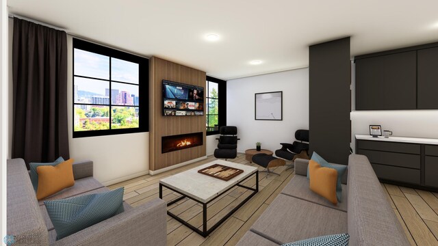 118 Broadway N Unit 802, Fargo, ND 58102 - living room featuring a warm lit fireplace, healthy amount of natural light, and light wood finished floors