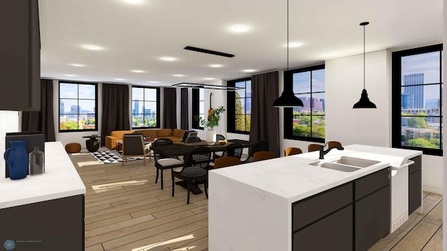 118 Broadway N Unit 803, Fargo, ND 58102 - kitchen with healthy amount of natural light, a center island with sink, pendant lighting, and open floor plan