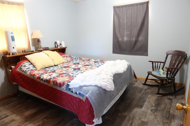 bedroom featuring baseboards and wood finished floors
