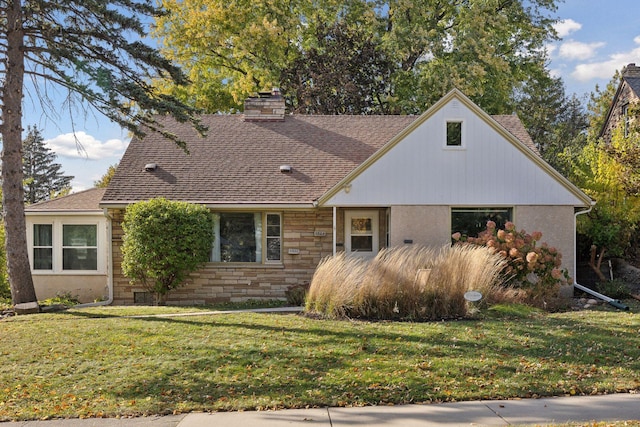 3522 Benjamin St NE, Minneapolis, MN 55418 - view of front of home featuring a front yard, a chimney, a shingled roof, and stone siding