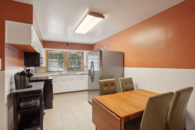 3522 Benjamin St NE, Minneapolis, MN 55418 - kitchen with stainless steel refrigerator with ice dispenser, white cabinetry, black electric range, light countertops, and decorative backsplash