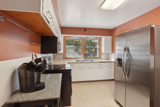 3522 Benjamin St NE, Minneapolis, MN 55418 - kitchen with stainless steel appliances, a sink, tasteful backsplash, white cabinets, and light tile patterned floors
