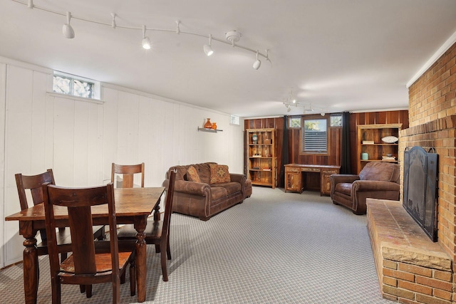3522 Benjamin St NE, Minneapolis, MN 55418 - dining space featuring a fireplace, carpet, wooden walls, and rail lighting
